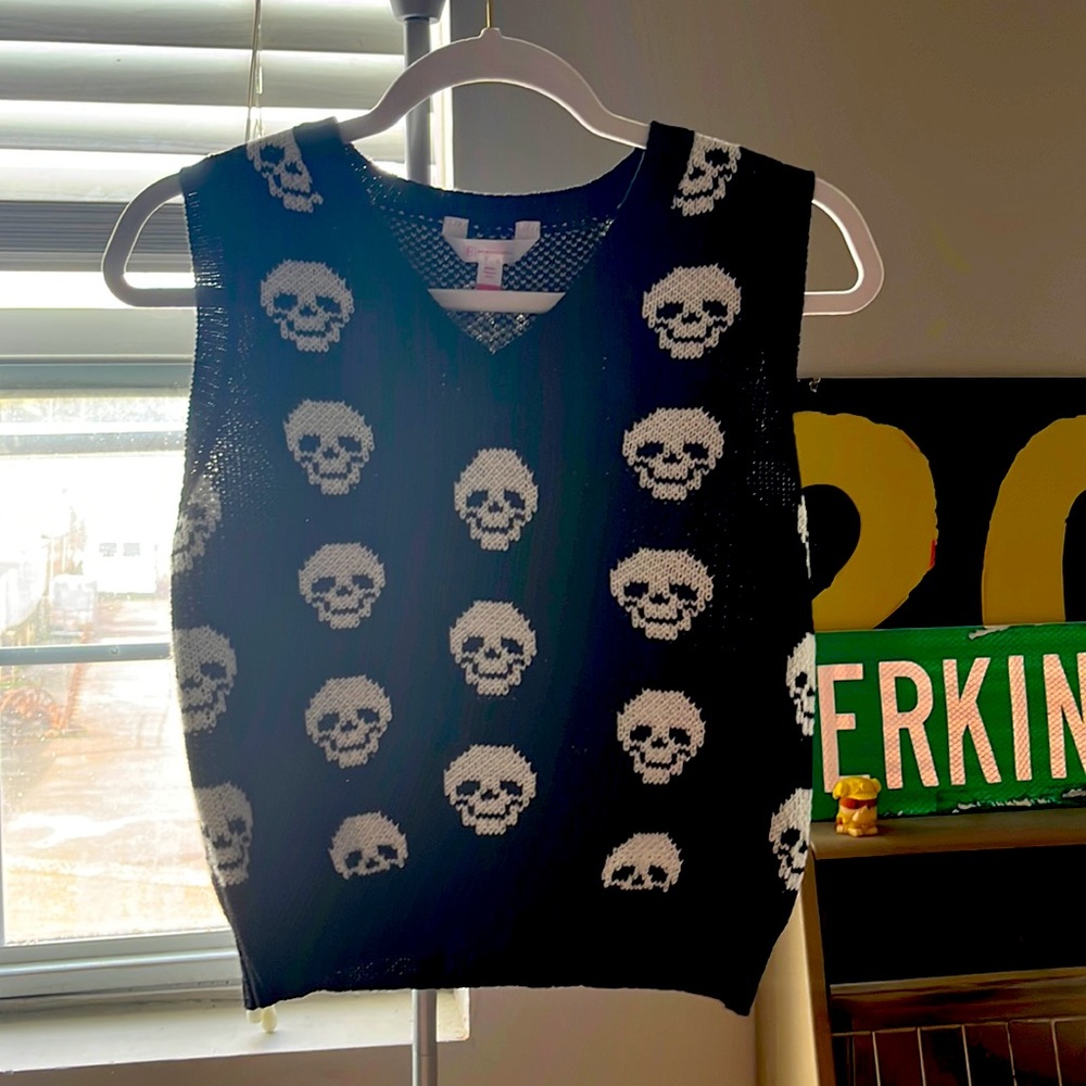 Black sweater vest with white skulls